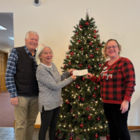 La Grande Branch manager presenting a check to two members from the La Grande Lions club.